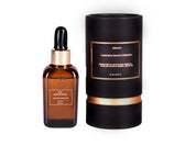 Luxury hair serum bottle with dropper and black packaging for hair care